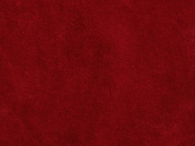 Arka plan olarak kırmızı kadife kumaş dokusu kullanılıyor. Yumuşak ve pürüzsüz tekstil malzemelerinden oluşan boş kırmızı kumaş arka plan. Metin için boşluk var.