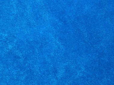 Arka plan olarak kullanılan açık mavi kadife kumaş dokusu. Yumuşak ve pürüzsüz tekstil malzemesinin boş açık mavi kumaş arkaplanı. 