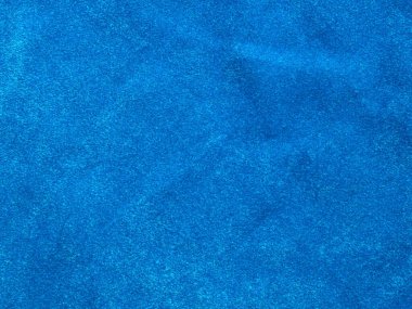 Arka plan olarak kullanılan açık mavi kadife kumaş dokusu. Yumuşak ve pürüzsüz tekstil malzemesinin boş açık mavi kumaş arkaplanı. 