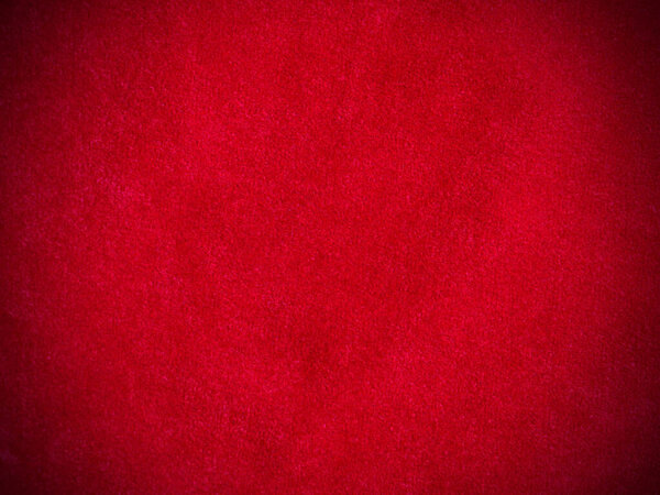 Красная бархатная ткань текстура используется в качестве фона. Пустой красный тканевый фон из мягкого и гладкого текстильного материала. Есть место для текста.