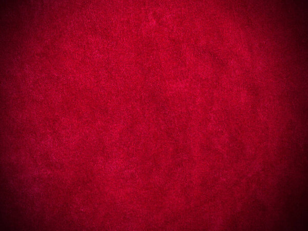 Красная бархатная ткань текстура используется в качестве фона. Пустой красный тканевый фон из мягкого и гладкого текстильного материала. Есть место для текста.