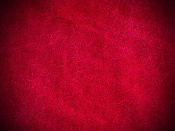 Красная бархатная ткань текстура используется в качестве фона. Пустой красный тканевый фон из мягкого и гладкого текстильного материала. Есть место для текста.