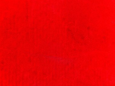 Arka plan olarak kırmızı kadife kumaş dokusu kullanılıyor. Yumuşak ve pürüzsüz tekstil malzemelerinden oluşan boş kırmızı kumaş arka plan. Metin için boşluk var.