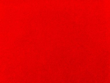 Arka plan olarak kırmızı kadife kumaş dokusu kullanılıyor. Yumuşak ve pürüzsüz tekstil malzemelerinden oluşan boş kırmızı kumaş arka plan. Metin için boşluk var.