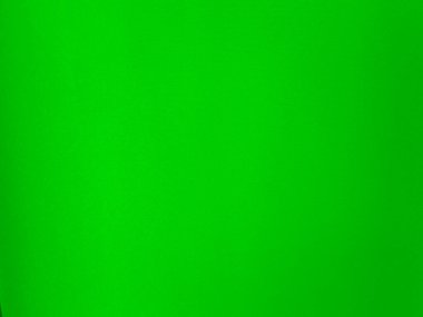 Arka plan olarak kullanılan parlak yeşil kadife kumaş dokusu. Yumuşak ve pürüzsüz tekstil malzemelerinden oluşan boş yeşil kumaş arka planı. Metin için boşluk var.