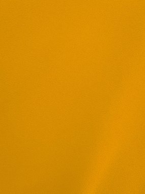 Yellow velvet fabric texture used as background. Empty yellow fabric background of soft and smooth textile material. There is space for text.	