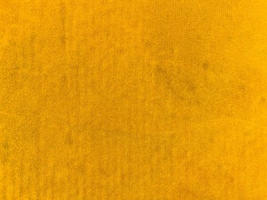 Yellow velvet fabric texture used as background. Empty yellow fabric background of soft and smooth textile material. There is space for text.	