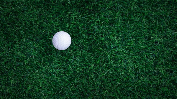 Golf ball close up on tee grass on blurred beautiful landscape of golf background. Concept international sport that rely on precision skills for health relaxation. top vie