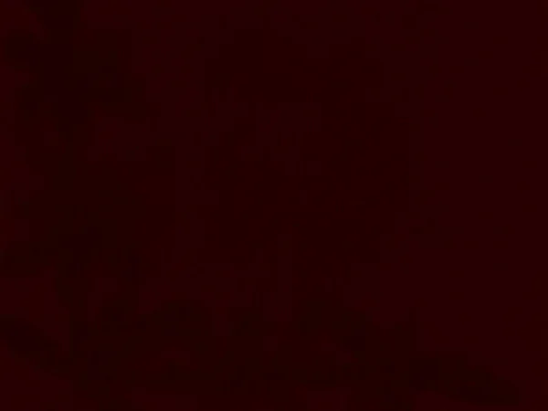 Dark red velvet fabric texture used as background. Empty dark red fabric background of soft and smooth textile material gradient. There is space for text.