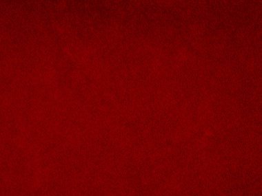Arka plan olarak kırmızı kadife kumaş dokusu kullanılıyor. Yumuşak ve pürüzsüz tekstil malzemelerinden oluşan boş kırmızı kumaş arka plan. Metin için boşluk var.