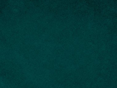 Arka plan olarak kullanılan koyu yeşil kadife kumaş dokusu. Yumuşak ve pürüzsüz tekstil malzemelerinden oluşan boş yeşil kumaş arka planı. Metin için boşluk var.