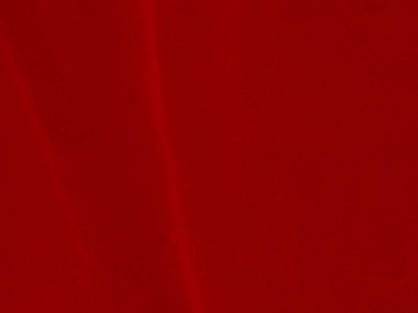 Arka plan olarak kırmızı kadife kumaş dokusu kullanılıyor. Yumuşak ve pürüzsüz tekstil malzemelerinden oluşan boş kırmızı kumaş arka plan. Metin için boşluk var.