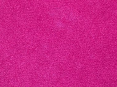 Arka plan olarak kullanılan pembe kadife kumaş dokusu. Yumuşak ve pürüzsüz tekstil malzemelerinin boş pembe kumaş arka planı. Tex için yer var.