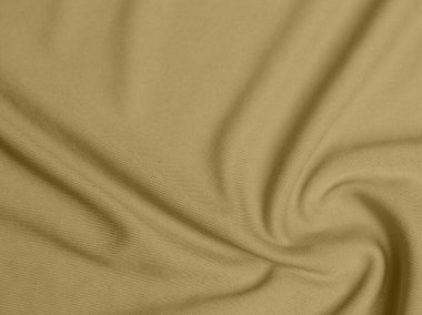 Altın rengi kadife kumaş dokusu arka plan olarak kullanılır. Yumuşak ve pürüzsüz tekstil malzemelerinin sarı renkli kumaş arka planı. Metin için boşluk var.