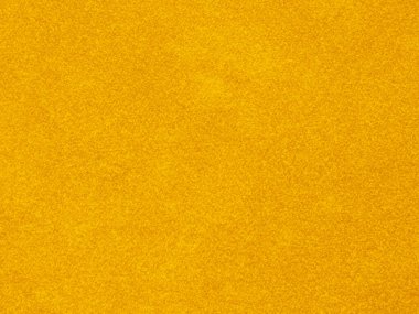 Arka plan olarak sarı kadife kumaş dokusu kullanılır. Yumuşak ve pürüzsüz tekstil malzemelerinden oluşan boş sarı kumaş arka plan. Tex için yer var.