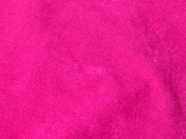 Arka plan olarak kullanılan pembe kadife kumaş dokusu. Yumuşak ve pürüzsüz tekstil malzemelerinin boş pembe kumaş arka planı. Metin için boşluk var.