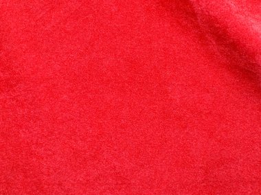 Arka plan olarak turuncu kadife kumaş dokusu kullanılır. Yumuşak ve pürüzsüz tekstil malzemelerinden oluşan boş turuncu kumaş arka plan. Metin için boşluk var.