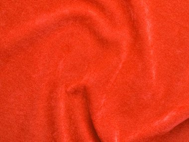 Arka plan olarak turuncu kadife kumaş dokusu kullanılır. Yumuşak ve pürüzsüz tekstil malzemelerinden oluşan boş turuncu kumaş arka plan. Metin için boşluk var.