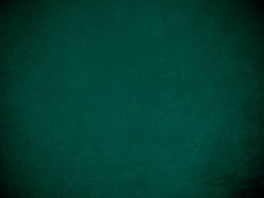Arka plan olarak kullanılan koyu yeşil kadife kumaş dokusu. Yumuşak ve pürüzsüz tekstil malzemesinin ton rengi yeşil kumaş arka planı. Metin ve tüm tasarım işleri için yer var