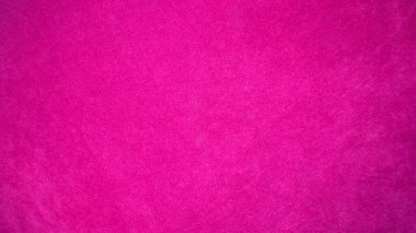 Arka plan olarak kullanılan pembe kadife kumaş dokusu. Yumuşak ve pürüzsüz tekstil malzemesinin ton rengi pembe kumaş arka planı. Metin ve tüm tasarım işleri için yer var