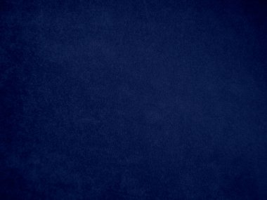 Arka plan olarak kullanılan koyu mavi kadife kumaş dokusu. Yumuşak ve pürüzsüz tekstil malzemesinin ton rengi mavi kumaş arka planı. Metin ve tüm tasarım işleri için yer var