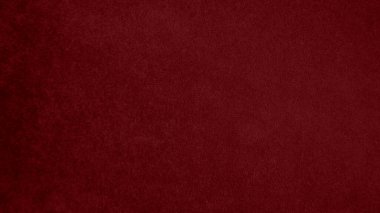 Arka plan olarak kullanılan koyu kırmızı kadife kumaş dokusu. Yumuşak ve pürüzsüz tekstil malzemesinin ton rengi kırmızı kumaş arka planı. Metin ve tüm tasarım işleri için yer var