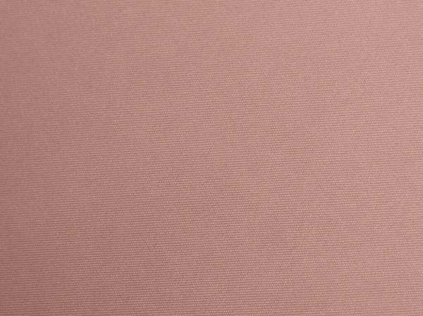 rose gold color velvet fabric texture used as background. Empty pink gold fabric background of soft and smooth textile material. There is space for text.