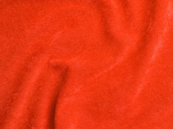 Arka plan olarak turuncu kadife kumaş dokusu kullanılır. Yumuşak ve pürüzsüz tekstil malzemelerinden oluşan boş turuncu kumaş arka plan. Metin için boşluk var.