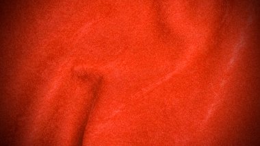 Arka plan olarak turuncu kadife kumaş dokusu kullanılır. Yumuşak ve pürüzsüz tekstil malzemelerinden oluşan boş turuncu kumaş arka plan. Metin için boşluk var.