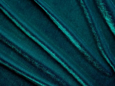 Dark green old velvet fabric texture used as background. Empty green fabric background of soft and smooth textile material. There is space for text..	