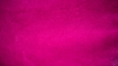 Arka plan olarak kullanılan pembe kadife kumaş dokusu. Yumuşak ve pürüzsüz tekstil malzemelerinin boş pembe kumaş arka planı. Metin için boşluk var.