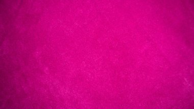 Arka plan olarak kullanılan pembe kadife kumaş dokusu. Yumuşak ve pürüzsüz tekstil malzemelerinin boş pembe kumaş arka planı. Metin için boşluk var.