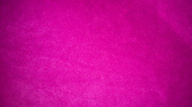 Arka plan olarak kullanılan pembe kadife kumaş dokusu. Yumuşak ve pürüzsüz tekstil malzemelerinin boş pembe kumaş arka planı. Metin için boşluk var.