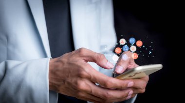 Concept with notification icons of like being happy.and social media interactions on mobile phone,message, email, comment ,businessman hands holding device,smartphone, internet digital marketing.	