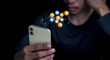 Concept with notification icons of like being happy.and social media interactions on mobile phone,message, email, comment ,businessman hands holding device,smartphone, internet digital marketing.	