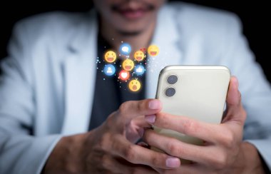 Concept with notification icons of like being happy.and social media interactions on mobile phone,message, email, comment ,businessman hands holding device,smartphone, internet digital marketing.	