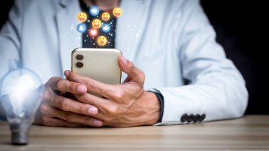Concept with notification icons of like being happy.and social media interactions on mobile phone,message, email, comment ,businessman hands holding device,smartphone, internet digital marketing.	