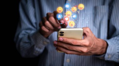 Concept with notification icons of like being happy.and social media interactions on mobile phone,message, email, comment ,businessman hands holding device,smartphone, internet digital marketing.	