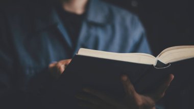 İş adamı elinde kitap ya da İncil tutarak problem çözmeyi düşünüyor. İş rekabeti planlama takım çalışması, Uluslararası kitap, fikirler ve rekabet ve strateji, iş başarısı konsepti, stratejik kavram.