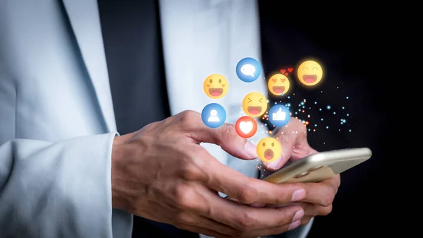 Concept with notification icons of like being happy.and social media interactions on mobile phone,message, email, comment ,businessman hands holding device,smartphone, internet digital marketing.