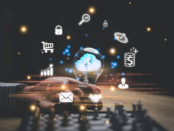 Businessman holding light bulb with virtual Global Internet connection.Digital marketing and global internet connection application technology, Digital link tech,Financial daily life.idea cloud.