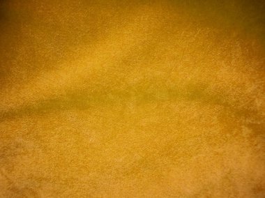 Yellow velvet fabric texture used as background. Empty yellow fabric background of soft and smooth textile material. There is space for text.	