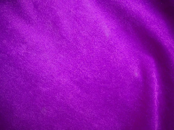 Purple velvet fabric texture used as background. Luxury violet fabric background of soft and smooth textile material. There is space for text.
