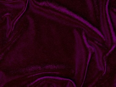 Arka plan olarak kullanılan mor kadife kumaş dokusu. Yumuşak ve pürüzsüz tekstil malzemelerinin boş mor kumaş arkaplanı. Metin için boşluk var