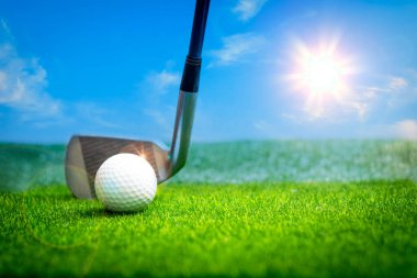 Golf ball close up on tee grass on blurred beautiful landscape of golf background. Concept international sport that rely on precision skills for health relaxation.	