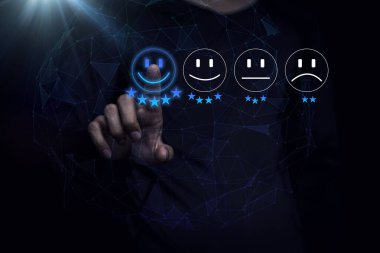 Businessman are touching the virtual screen on the happy Smiley face icon to give satisfaction in service. rating very impressed.digital marketing,Customer service and satisfaction concept.	
