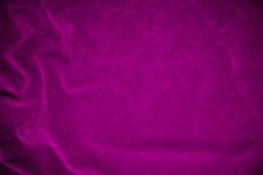 Arka plan olarak kullanılan pembe kadife kumaş dokusu. Yumuşak ve pürüzsüz tekstil malzemelerinden oluşan pembe kumaş. Metin için boşluk var.