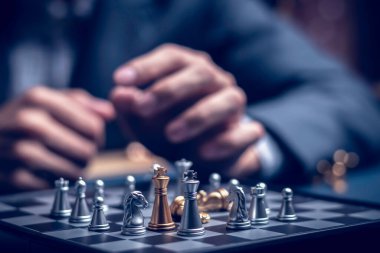 Businessman playing chess think problem solving. business competition planning teamwork,International chess, ideas and competition and strategy, business success concept,strategic concept..	