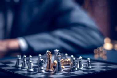 Businessman playing chess think problem solving. business competition planning teamwork,International chess, ideas and competition and strategy, business success concept,strategic concept..	