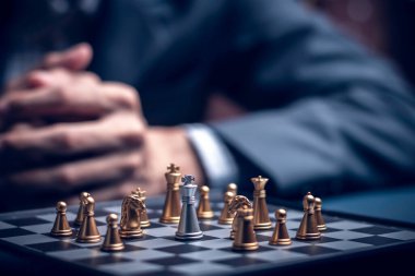 Businessman playing chess think problem solving. business competition planning teamwork,International chess, ideas and competition and strategy, business success concept,strategic concept..	